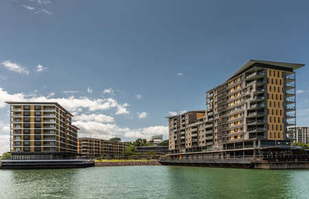 Darwin Australia - February 22, 2019: Closeup of Wharf One residential and retail business buildings on pontons in Kitchener bay of harbour. Evening cloudscape.のeditorial素材