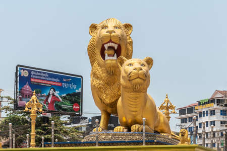 Sihanoukville, Cambodia - March 15, 2019: Golden Lions Roundabout. Closeup front of giant statues of the beasts. Lanterns, Construction sites in back.のeditorial素材