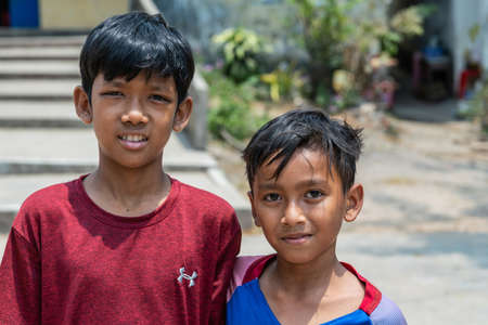 Sihanoukville, Cambodia - March 15, 2019: Phsar Leu Elementary School. closeup portrait of bust of two boys, smiling. One taller than other.のeditorial素材