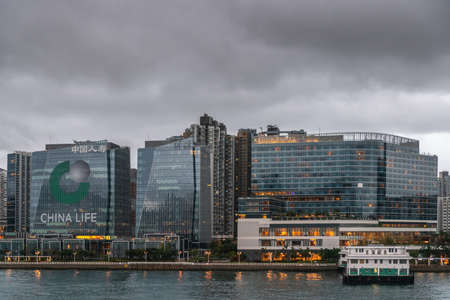 Hong Kong, China - March 7, 2019: Very early morning under dark rainy sky. Kowloon Bay, skyline at...