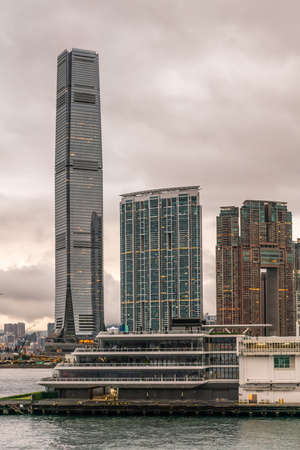 Hong Kong, China - March 7, 2019: Very early morning under dark rainy sky. Portrait of Kowloon...