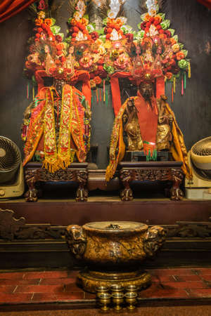 Hong Kong, China - March 8, 2019: Man Mo Yi Tai Taoist Temple in Fu Shin Street. The two leading idols, Man Tai and Mo tai, God of War and of Literature draped in reds and gold, under flowers and feathers.のeditorial素材