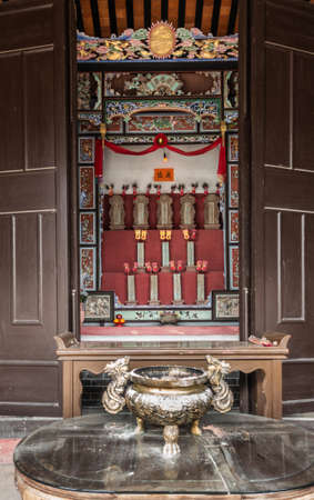 Hong Kong, China - March 8, 2019: New Territory. Tang Family Ancestral Home, turned into museum and cultural center. Names of oldest founding family members on display. Setting of altar.のeditorial素材
