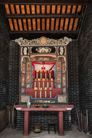 Hong Kong, China - March 8, 2019: New Territory. Tang Family Ancestral Home, turned into museum and cultural center. Names of oldest founding family members on display. Setting of altar.のeditorial素材