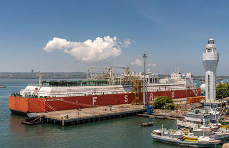 Bali, Indonesia - February 25, 2019: Red and white Floating Storage and Regasification Unit, FSRU, LNG-vessel in Benoa Harbour under light blue sky.のeditorial素材