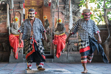 Banjar Gelulung, Bali, Indonesia - February 26, 2019: Mas Village. Play on stage setting. Two bandits dance dressed with gray-white checkered shirts.のeditorial素材