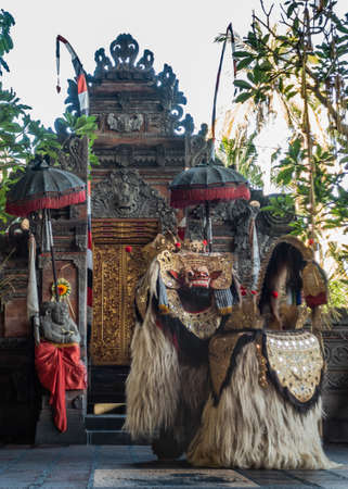 Banjar Gelulung, Bali, Indonesia - February 26, 2019: Mas Village. Play on stage setting. Four legged monster-king played by two actors in elaborate hairy costume and golden mask at temple building.のeditorial素材
