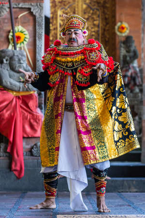 Banjar Gelulung, Bali, Indonesia - February 26, 2019: Mas Village. Play on stage setting. Closeup of lead Mandarin in traditional garb with pinks, golds, blacks, white and reds.のeditorial素材