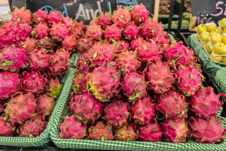 Ubud, Bali, Indonesia - February 26, 2019: Downtown Pedang Tegal, Ji. Hanoman street, commercial district. Closeup of baskets of pink dragon fruits on display.のeditorial素材
