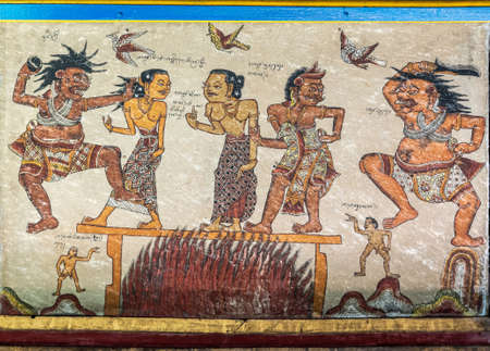 Klungkung, Bali, Indonesia - February 26, 2019: Kertha Gosa, Open sides Royal Court of Justice, ceiling full of paintings about punishments for bad behavior and rewards for good conduct. Close up of 6/13. Burning alive.のeditorial素材