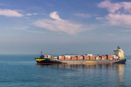 Makassar, Sulawesi, Indonesia - February 28, 2019: Closeup of Situ Mas container ship of Temas Lines sailing outside de harbor on blue flores Sea under morning sky.のeditorial素材