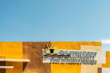 Puerto Princesa, Palawan, Philippines - March 3, 2019: Closeup of sign of Philippine Port Authority on colorfully painted wall against blue sky.のeditorial素材