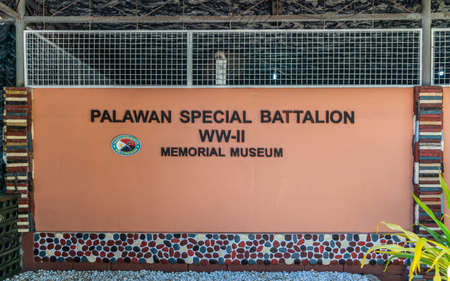 Puerto Princesa, Palawan, Philippines - March 3, 2019: Sign of black characters on red of Palawan Special Battalion WW-II Museum.のeditorial素材