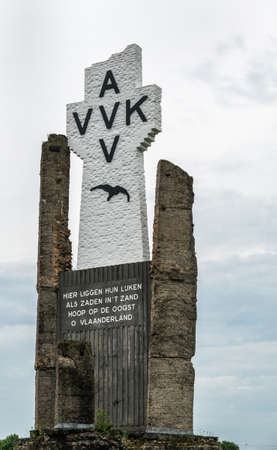 Diksmuide, Flanders, Belgium -  June 19, 2019: Closeup of Black on White Crypt memorial, remnants of dynamited tower, at site of IJzertoren, tallest peace monument of WW 1 against gray cloudscape.のeditorial素材