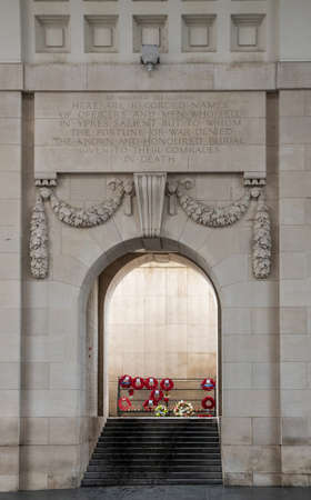Diksmuide, Flanders, Belgium -  June 19, 2019: Historic Menin Gate. Steps up leading to dispaly of wreaths with red poppies. Beige wall with remembrance declaration.のeditorial素材