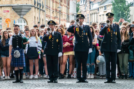 Diksmuide, Flanders, Belgium -  June 19, 2019: Historic Menin Gate. Last Post performance by four men musicians. Rows of English school girls in back.のeditorial素材