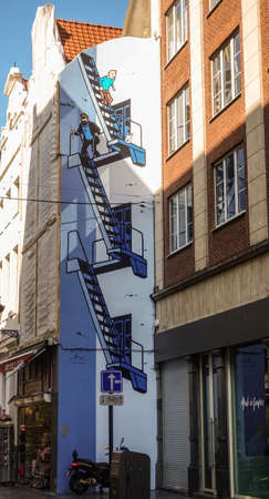 Brussels, Belgium - June 22, 2019: Tintin themed blue-white wall painting of stairway on side facade of house in Rue de lâEtuve.のeditorial素材