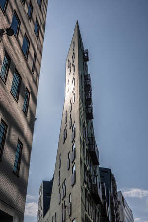 Amsterdam, the Netherlands - June 30, 2019: Trangular high rise office building and hotel ending in...