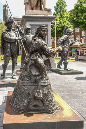 Amsterdam, the Netherlands - July 1, 2019: De Nachtwacht compostion of statues on Rembrandtplein. full body of sole female figure with other statues in back.のeditorial素材