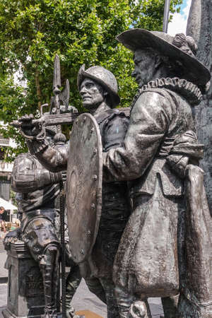 Amsterdam, the Netherlands - July 1, 2019: De Nachtwacht compostion of statues on Rembrandtplein. Closeup of body of three soldier figures against green foliage.のeditorial素材