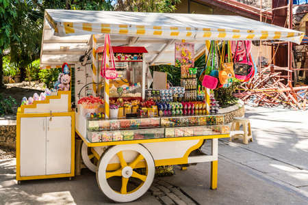Balabag, Boracay Island, Philippines - March 4, 2019: DâMall de Boracay. Yellow and white candy push cart sells sweets and cheap children gifts.のeditorial素材