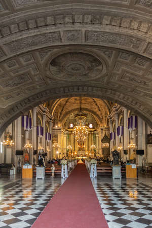 Manila, Philippines - March 5, 2019: San Augustin church. Shot from entrance: hall under bowing ceiling with frescoes, the nave and lighted chancel with wedding in progress.のeditorial素材