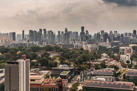 Singapore - March 20, 2019: Shot over hundreds of skyscrapers under heavy cloudy sky. Centered on fort Canning park and hotel.のeditorial素材