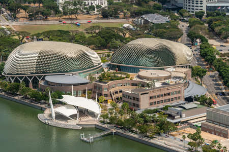 Singapore - March 21, 2019: Shot from Sands roof. Birds eye closeup of  Esplanade Theatres with its two domes. Green foliage of parks and lanes around.のeditorial素材