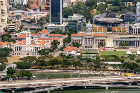 Singapore - March 21, 2019: Shot from Sands roof. Birds eye view on white Victoria Theatre with clock tower, National Gallery museum with Spaceship on top of Supreme Court.のeditorial素材