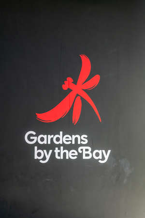 Singapore - March 22, 2019: At Gardens by the Bay. Red and white on black logo of Gardens by the Bay, as seen on entrance to park.のeditorial素材