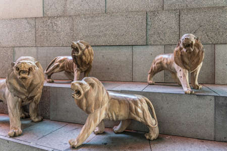 Singapore - March 22, 2019: Gardens by the Bay, the Flower Dome. Four lions out of large group of brown lion statues on steps outside the dome.のeditorial素材