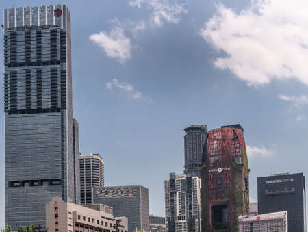 Singapore - March 22, 2019: Group of modern tall skyscraper and other buildings of hotels around Pecl Seah Street neighborhood under blue sky. Plants grow on side of one.のeditorial素材