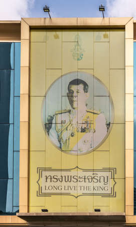 Bangkok city, Thailand - March 17, 2019: Portrait painting of King captured in circle on yellow background on wall in Soi Charoen Krung 24, a street, downtown, and slogan Long Live The King.のeditorial素材