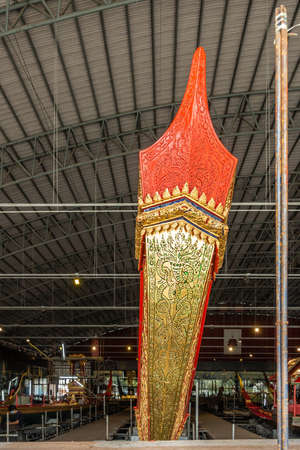 Bangkok city, Thailand - March 17, 2019: Royal Barge National Museum. Closeup of red and golden top of figurehead and prow of Royal Barge Anekchart Phu-Chong set in wider hall.のeditorial素材