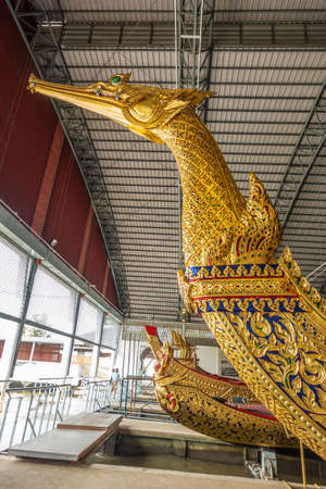 Bangkok city, Thailand - March 17, 2019: Royal Barge National Museum. Row of golden barge prows with Ekachai Hern Hao Royal Barge first in line.のeditorial素材