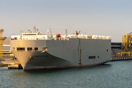 Laem Chabang seaport, Thailand - March 17, 2019: Closeup of tall large gray vehicles transport ship,...