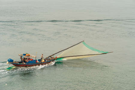 Da Nang, Vietnam - March 10, 2019: Tien Sa Port in Da Nang Bay. Small fishing boat with green front...