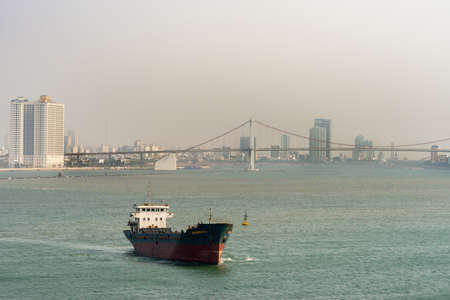 Da Nang, Vietnam - March 10, 2019: Tien Sa Port in Da Nang Bay. Binh Nguyen bulk cargo ship leaves...