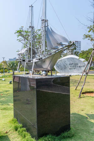 Da Nang, Vietnam - March 10, 2019: Memorial Park. Closeup of Indonesian metal statue of traditional trading ship on black pedestal in green environment under blue sky.のeditorial素材