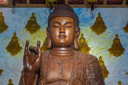 Da Nang, Vietnam - March 10, 2019: Chua An Long Chinese Buddhist Temple. Bust of brown wooden...