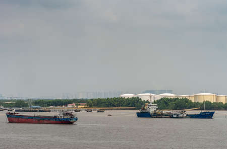 Long Tau River, Vietnam - March 12, 2019: 2 Cargo vessels on Long Tau River in front of Ho Chi Minh...