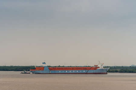 Long Tau River, Vietnam - March 12, 2019: Vinashin vessel with company corruption scandal slogan, He...