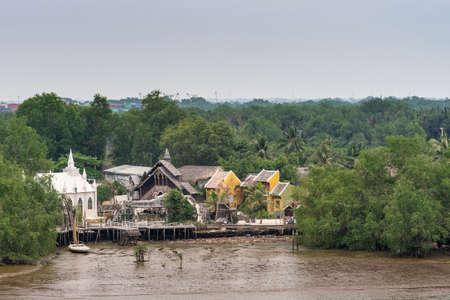Ho Chi Minh City Vietnam - March 12, 2019: Song Sai Gon river. Lâ Amour Film school and studio hidden in green foliage shows white church-like building and more constructions. Light blue sky.のeditorial素材