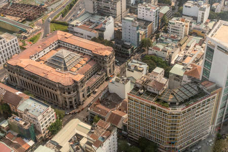 Ho Chi Minh City, Vietnam - March 12, 2019: Downtown. Closeup of square Vietnam Banking Association building among high rise buildings in wider cityscape.のeditorial素材