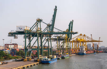 Ho Chi Minh City, Vietnam - March 13, 2019: Vict port on Song Sai Gon river at sunset. Container...