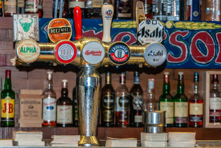 Melbourne, Australia - December 16, 2009: Cookie Thai eatery and beer hall. Closeup of ice-cold metal tapping installation with signs of multiple brands of beer. Bottles and colors added by drink brands.のeditorial素材