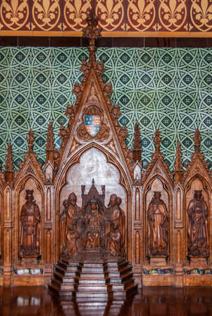 Melbourne, Australia - December 16, 2009: Saint Patrick Cathedral. Carved wooden brown sculpture of several saints and crowning in front of light green and black background.のeditorial素材