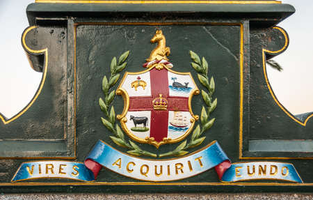 Melbourne, Australia - November 17, 2009: Closeup of Melbourne coat of arms, reading Vires Acquirit Eundo with shield. Meaning is Getting Strength along the Way.のeditorial素材