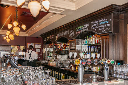 Melbourne, Australia - December 17, 2009: European Cafe on corner of Exhibition and Collins. The bar with taps, bottles, servers and plenty of glassware.のeditorial素材