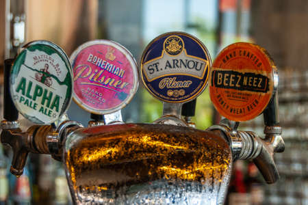 Melbourne, Australia - December 17, 2009: Stylish Riverside drinking and dining spot at Transport Hotel. Closeup of the names of specialty beers on tap installation with 4 handles.のeditorial素材